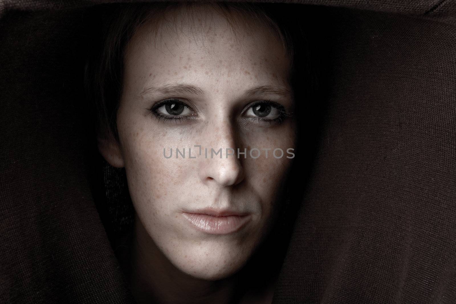 Studio portrait of a cute and beautifull girl in a turtle neck sweater looking mesmerizing