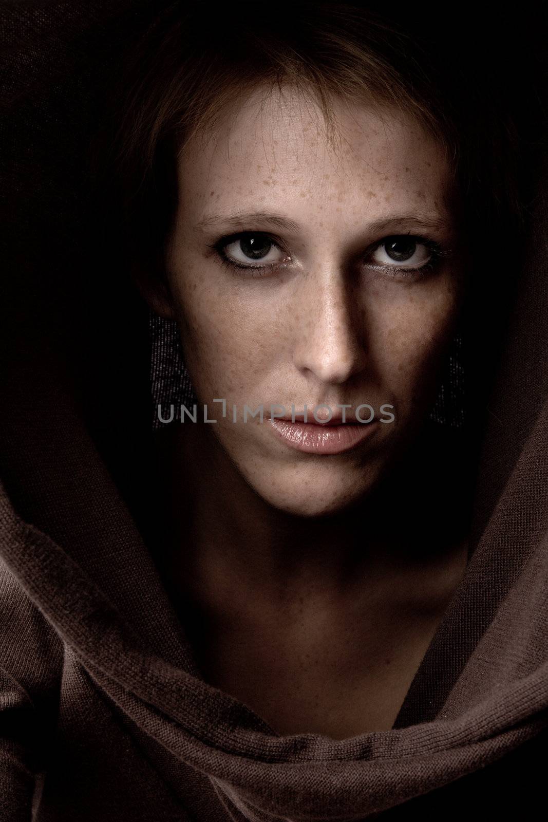 Studio portrait of a cute and beautifull girl in a turtle neck sweater making eye contact