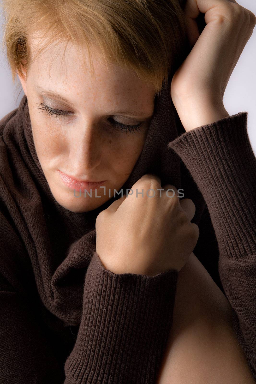 Studio portrait of a cute and beautifull girl in a turtle neck sweater