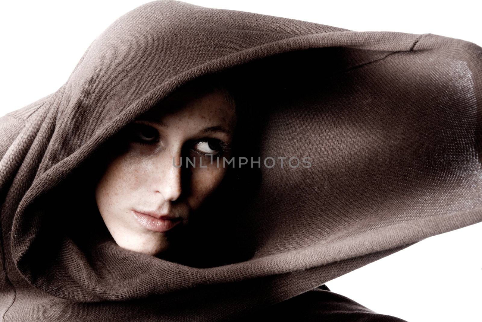 Studio portrait of a cute and beautifull girl in a turtle neck sweater looking aside