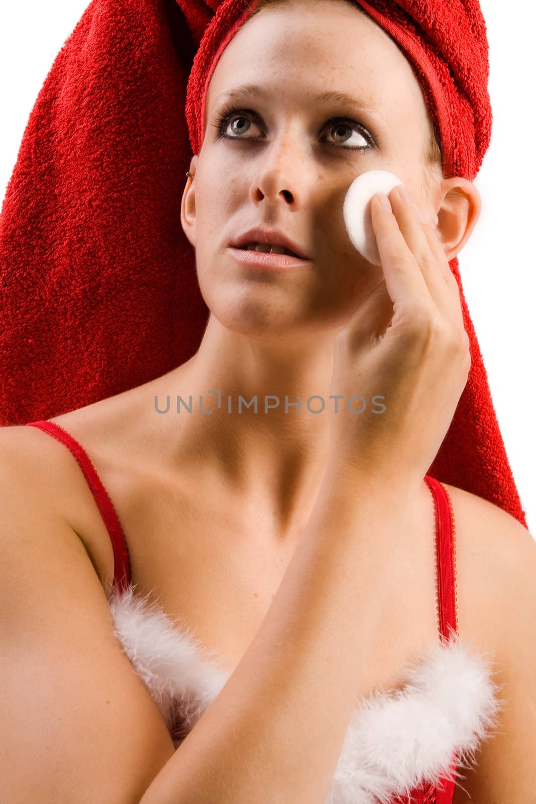 Studio portrait of a beautifull girl who is moisturizing her face