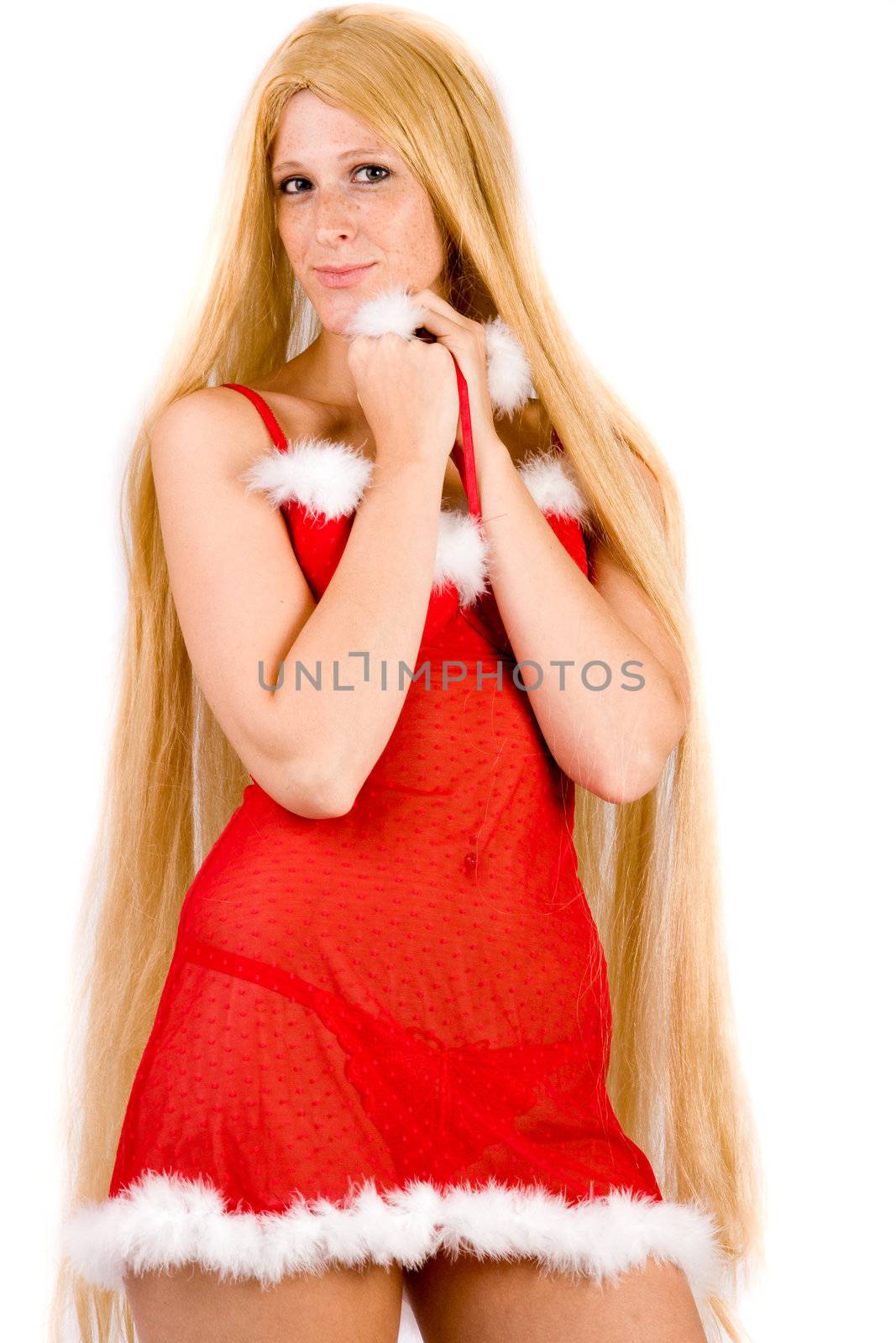 Studio portrait of blond christmas girl with very long blond hair looking shy