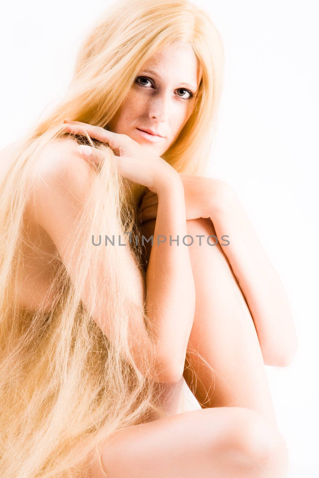 High key studio shot a an artistic girl with very long blond hair