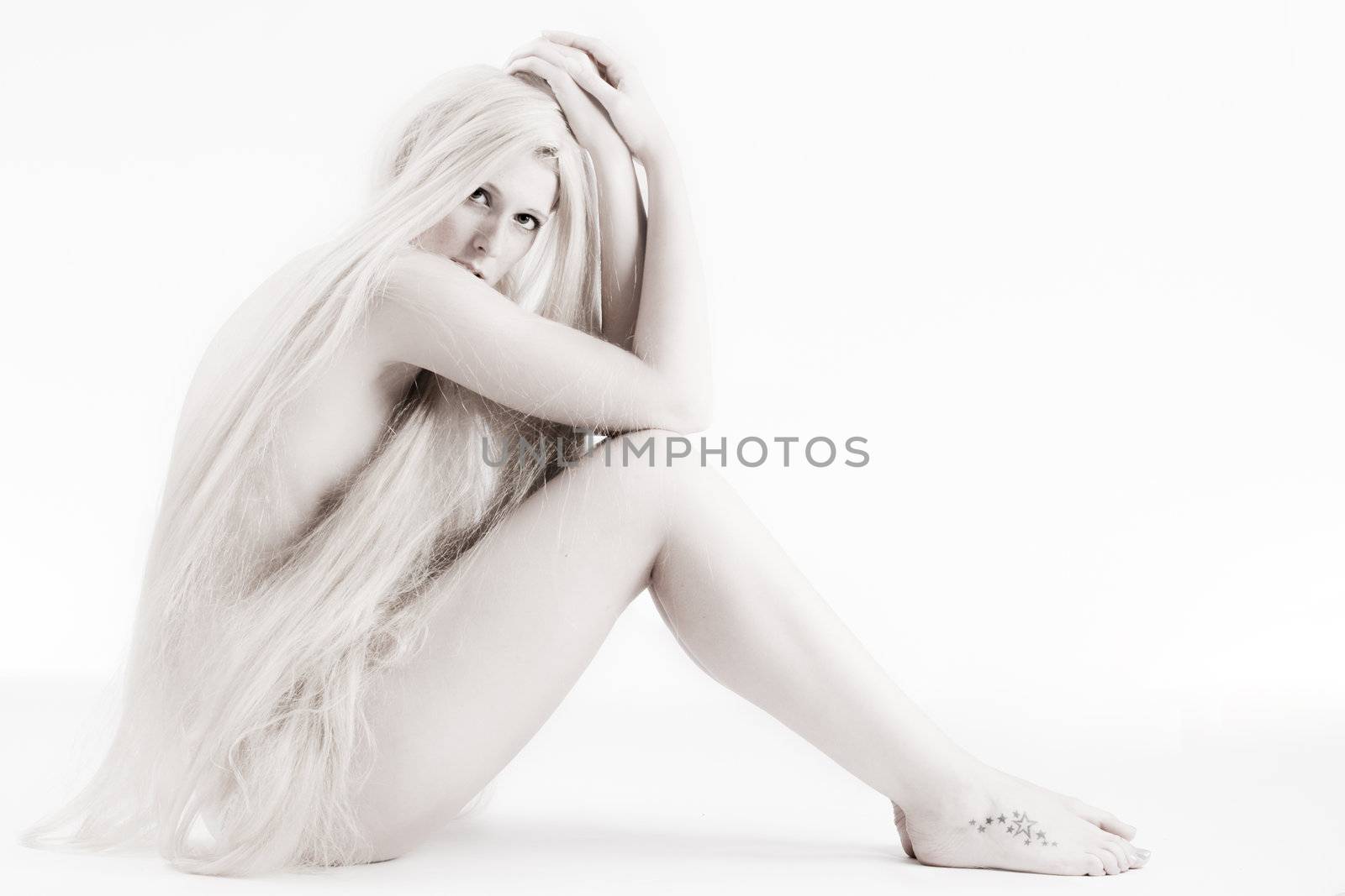 High key studio shot a an artistic girl with very long blond hair