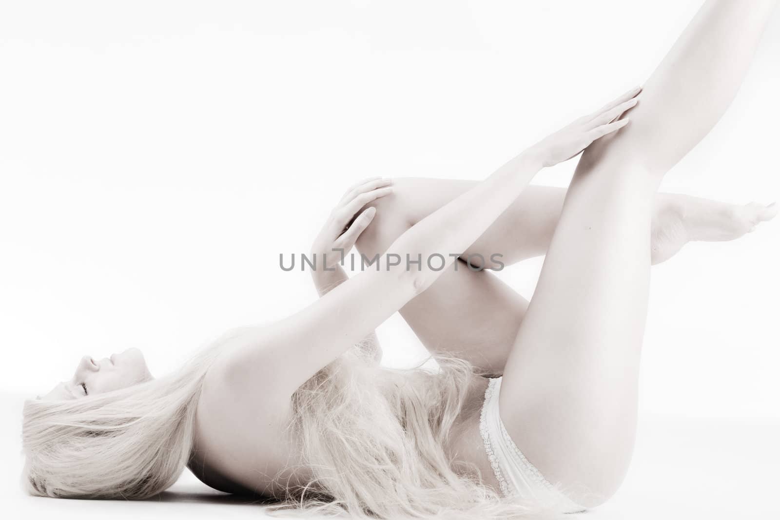 High key studio shot a an artistic girl with very long blond hair