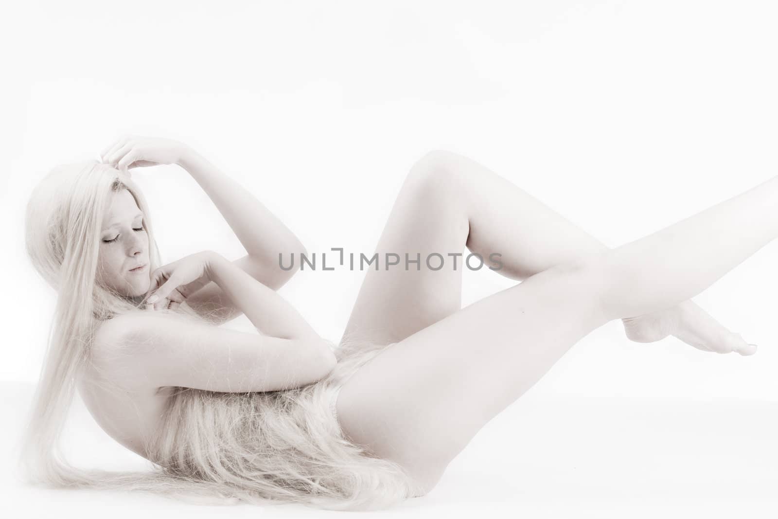 High key studio shot a an artistic girl with very long blond hair