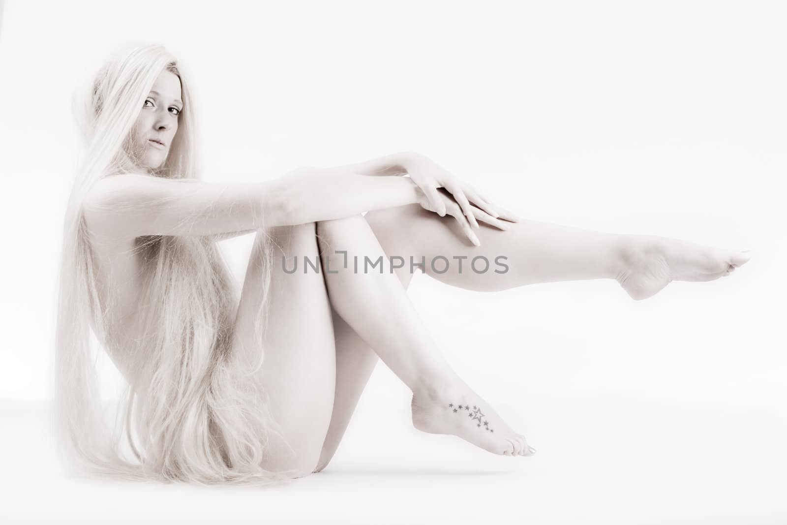 High key studio shot a an artistic girl with very long blond hair