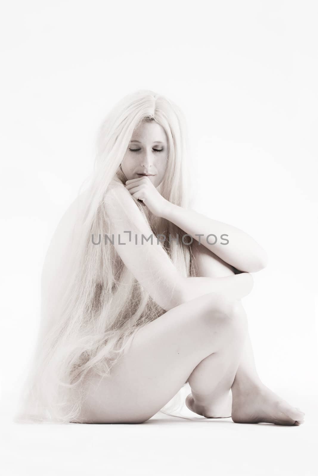 High key studio shot a an artistic girl with very long blond hair