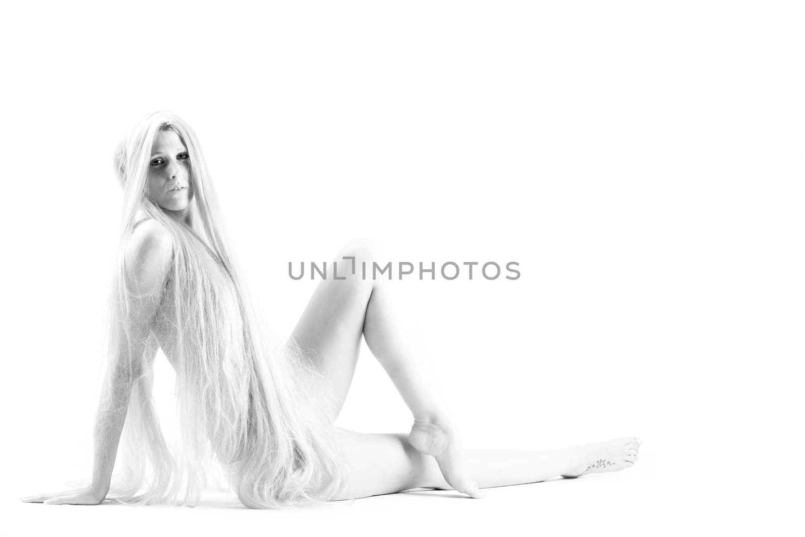 High key studio shot a an artistic girl with very long blond hair