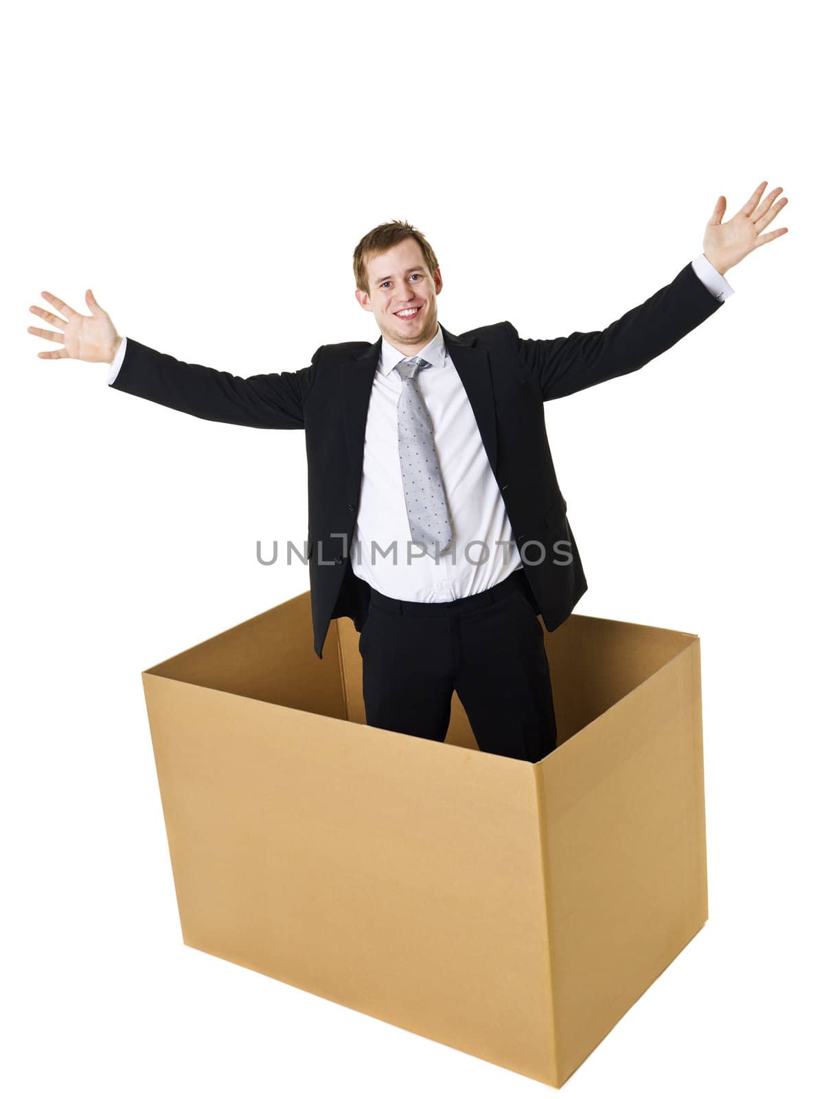 Businessman in a cardboard box isolated on white background