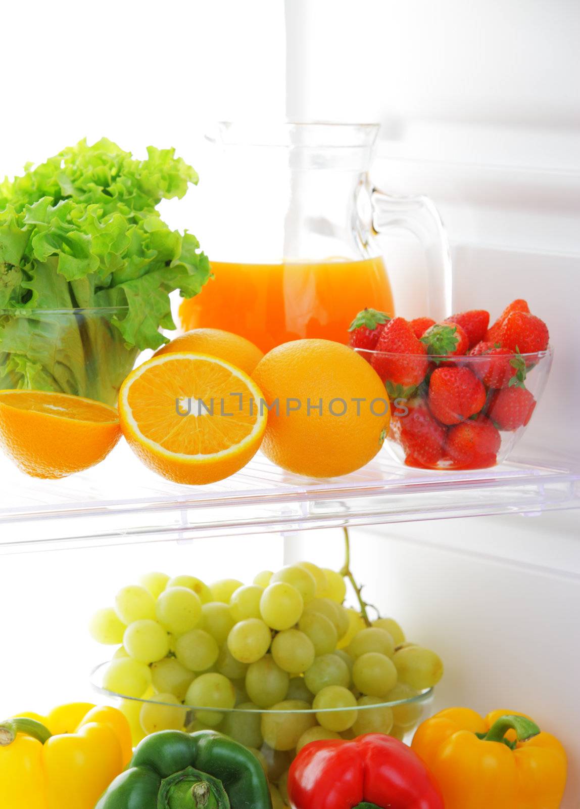 close up of a refrigerator with fruits and vegetables