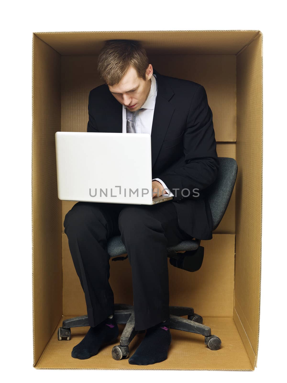 Businessman in a very tight office isolated on white background