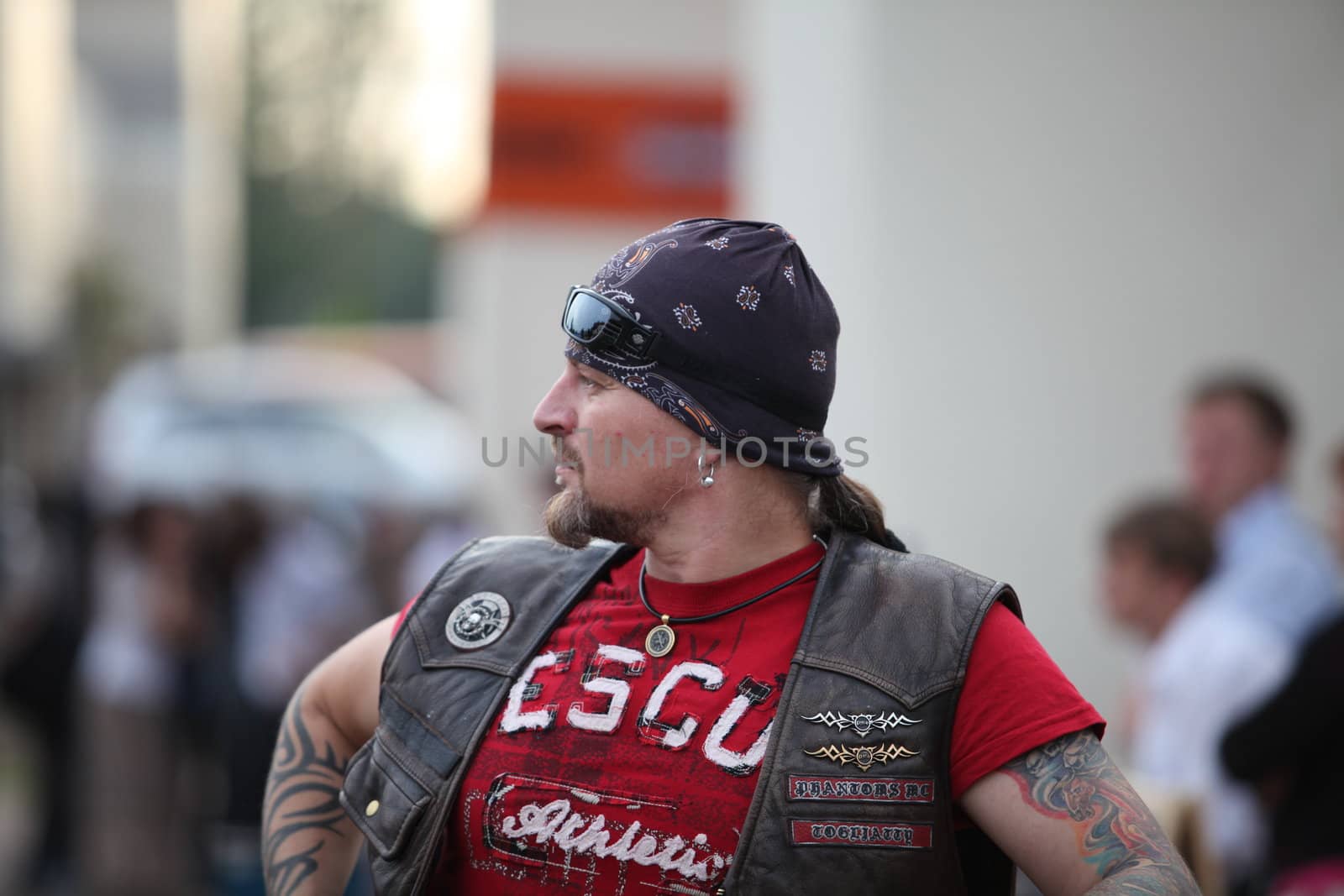 man in a bandana and tattoos on his hands