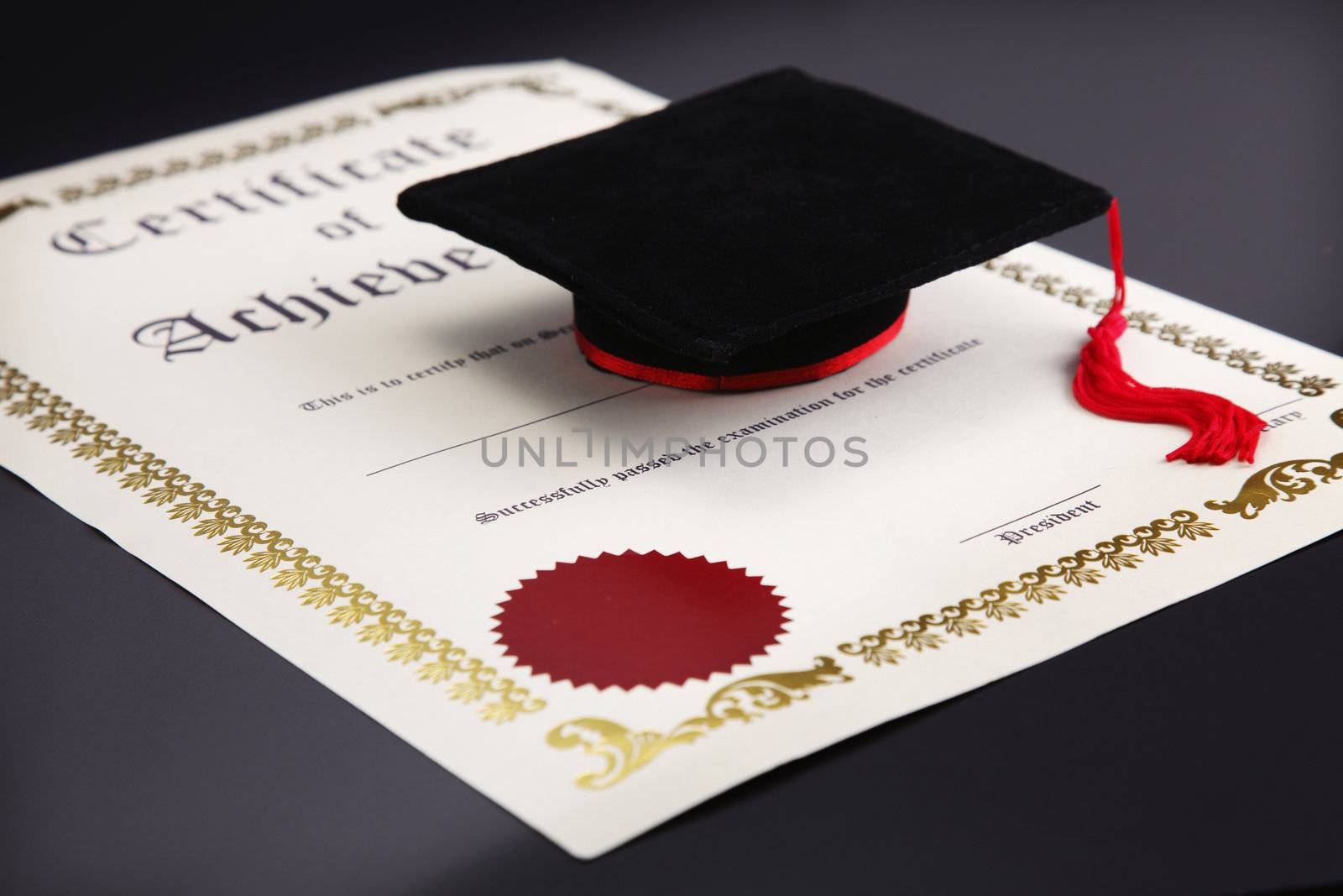 mini mortar board on the blank certificate