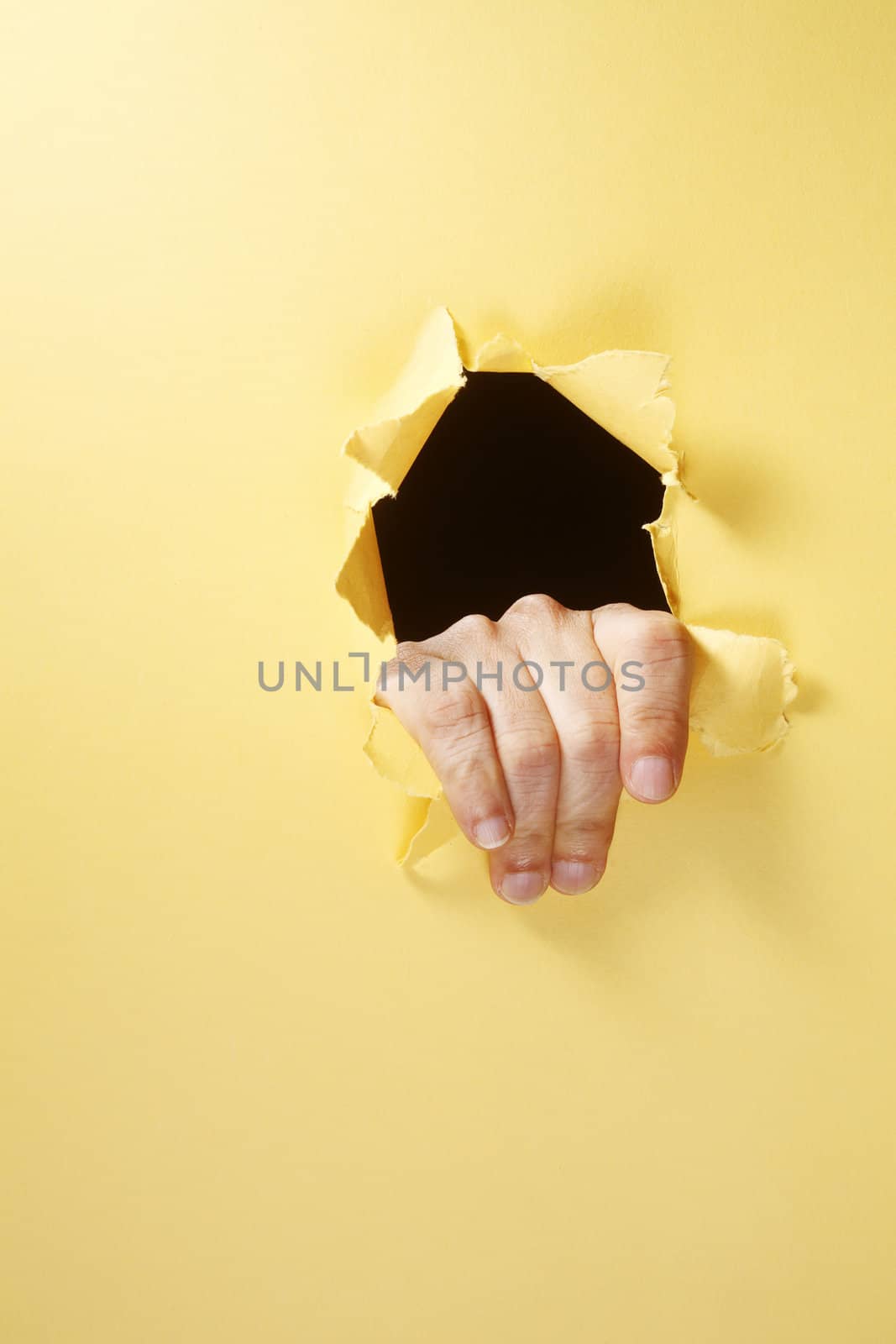 stock image of the hand breaking through a hole