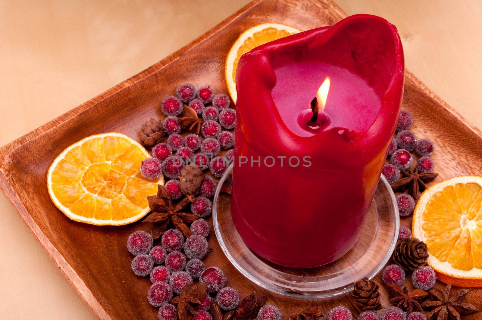 Burning Red Christmas Candle With Decorations