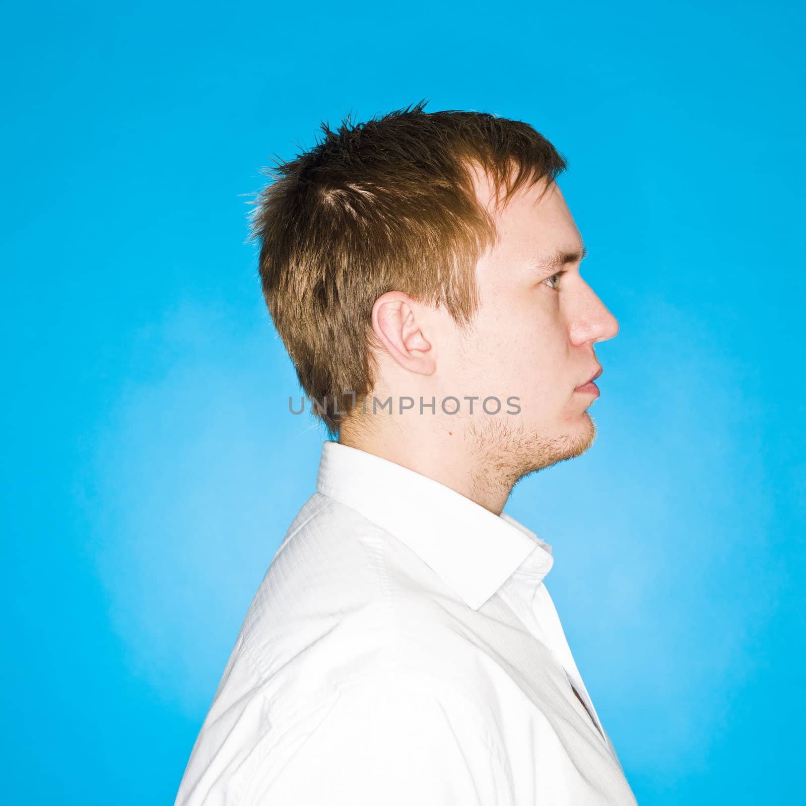 Portrait of a young man on blue background
