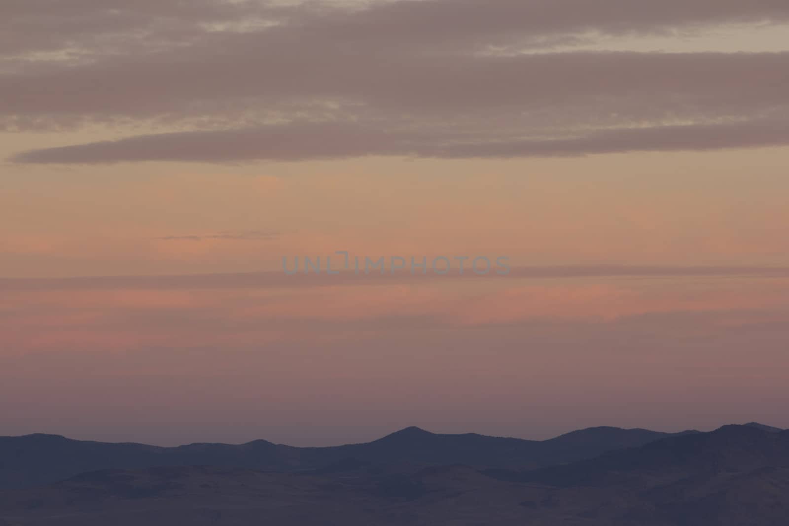 High desert sunset mountain with clouds by jeremywhat