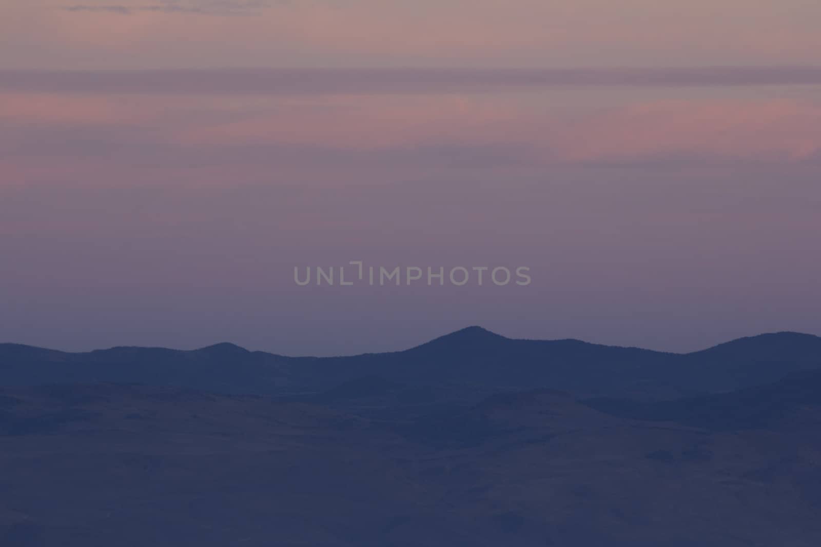 High desert sunset mountain with clouds by jeremywhat