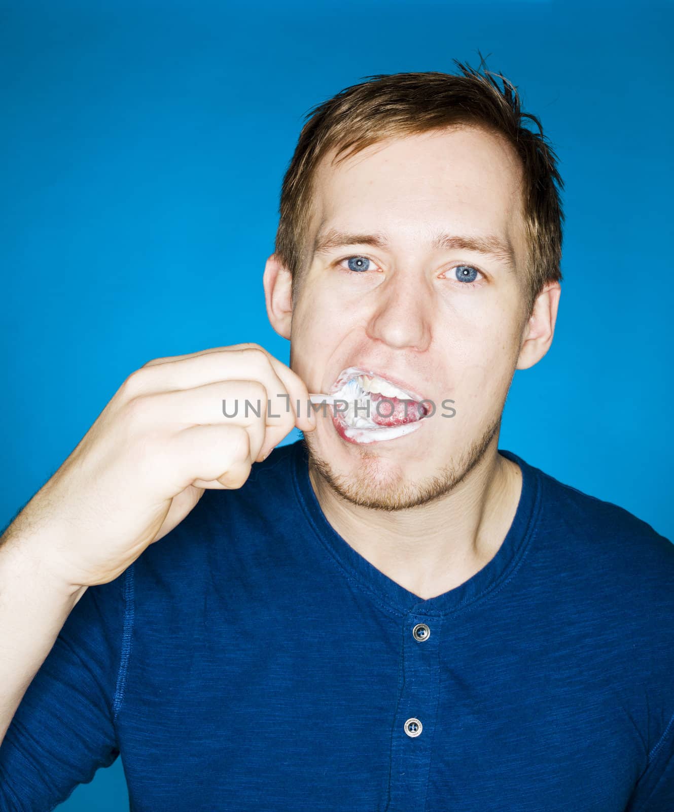 Close up of a man brushing teeths