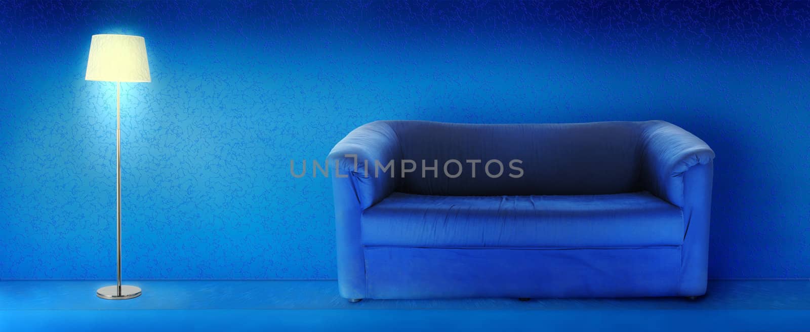 Floor vintage lamp and couch over blue grunge background.