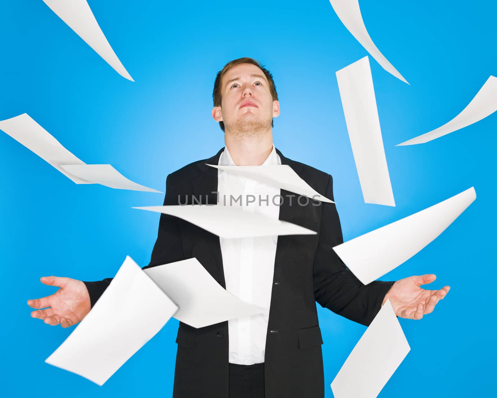 Man and flying papers on blue background