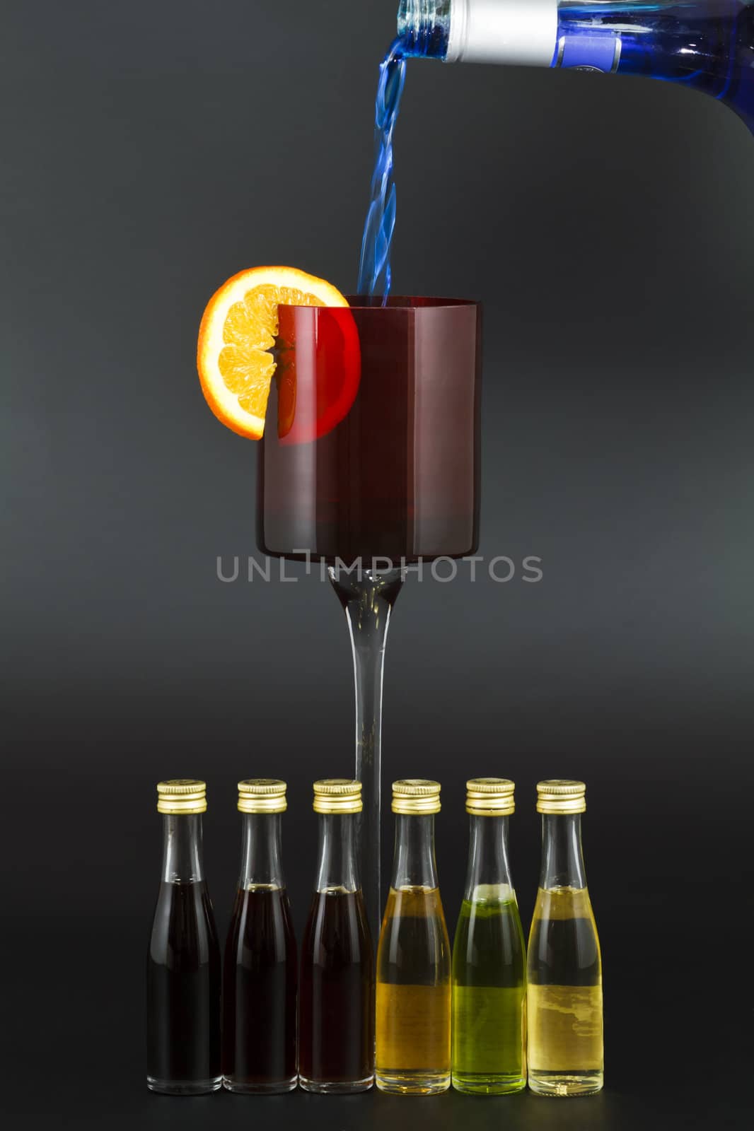 Red Liqour Glass with Orange slice and small liqour bottles