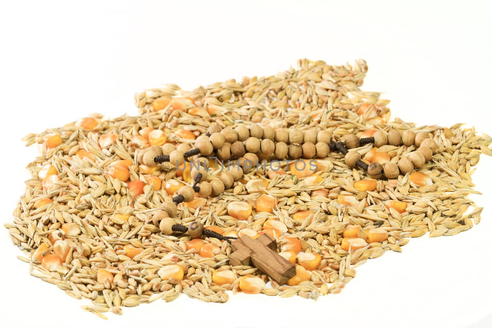 Different types of wheat grains with wooden cross on the top