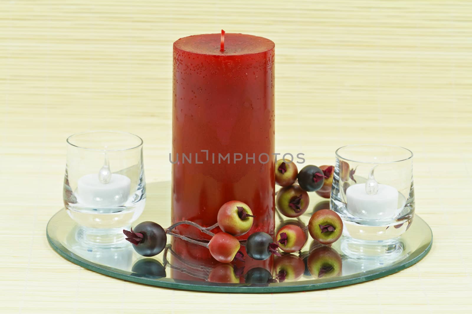 Beautiful home decoration with candle and decorative flower on small brown bamboo rug 