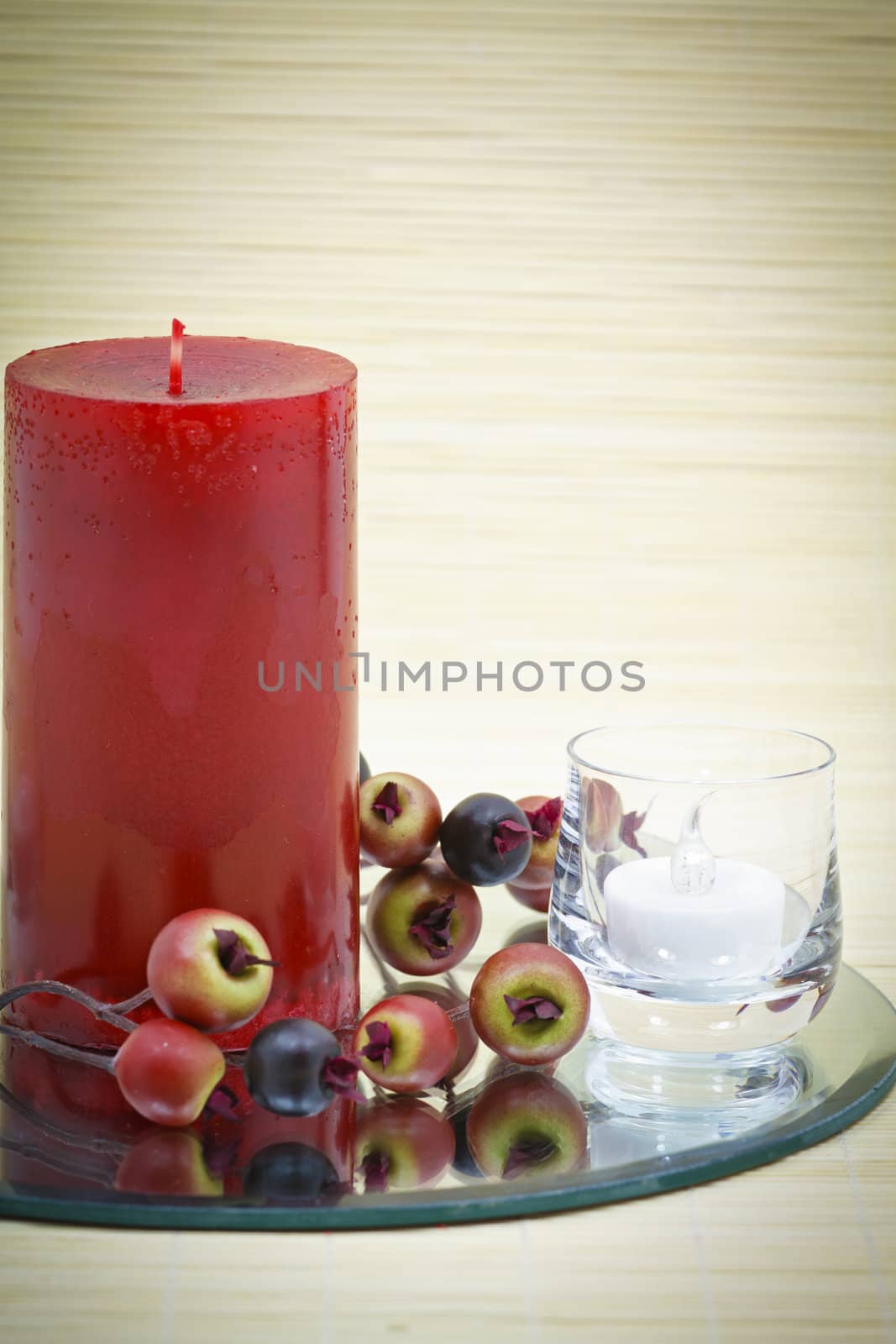 Beautiful home decoration with candle and decorative flower on small brown bamboo rug 