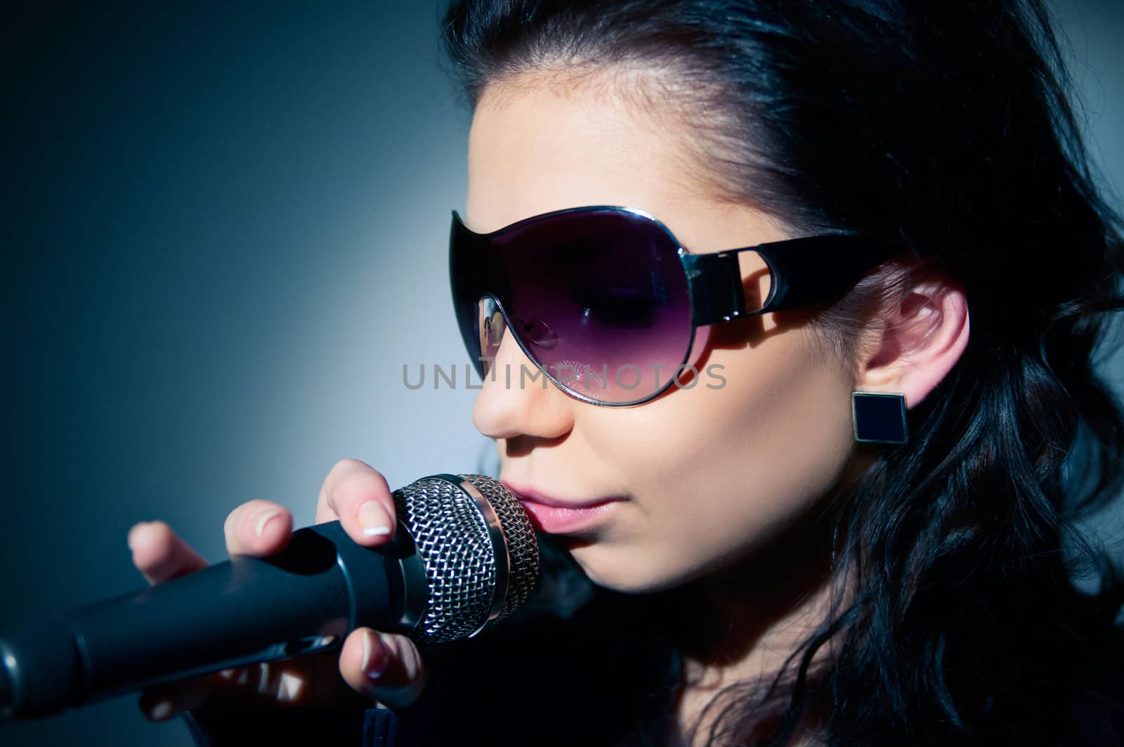Girl Singing. Close-up of a young woman singing on stage