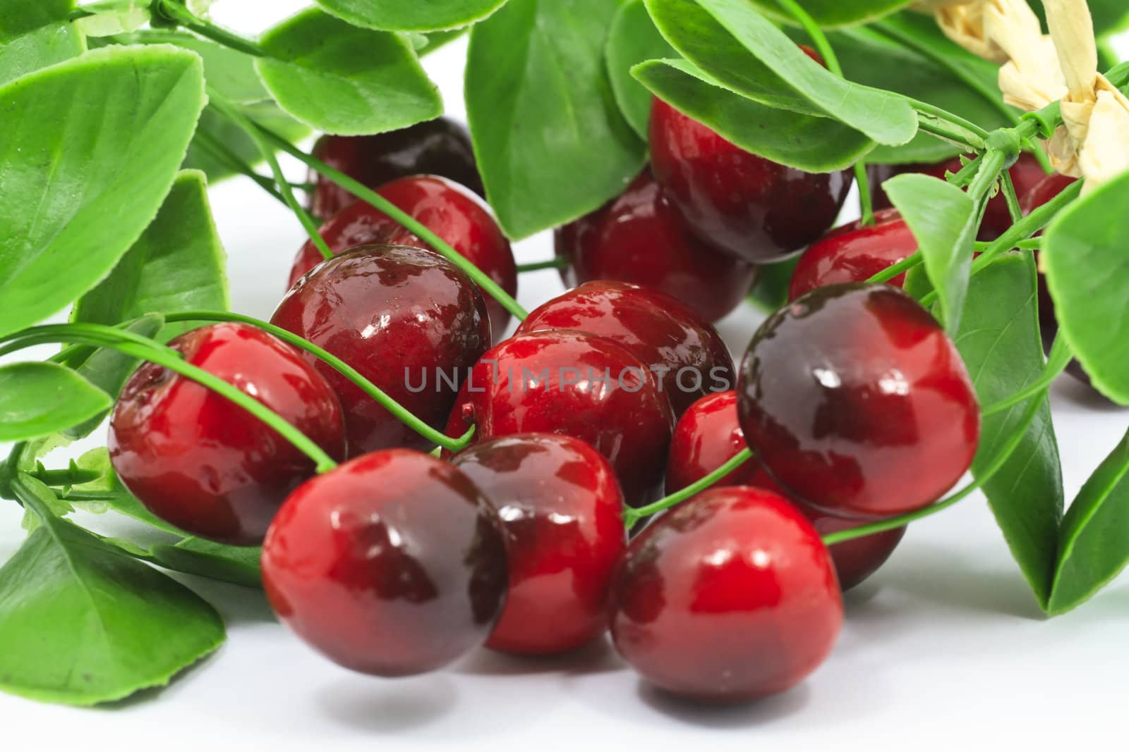 Sweet red cherries with leaves isolated on wite background
