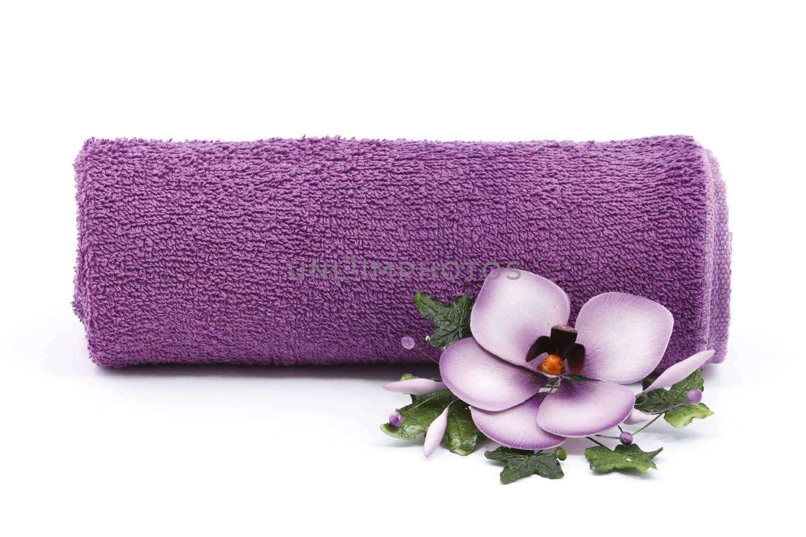 Purple towel and flower as a spa decoration isolated on white background