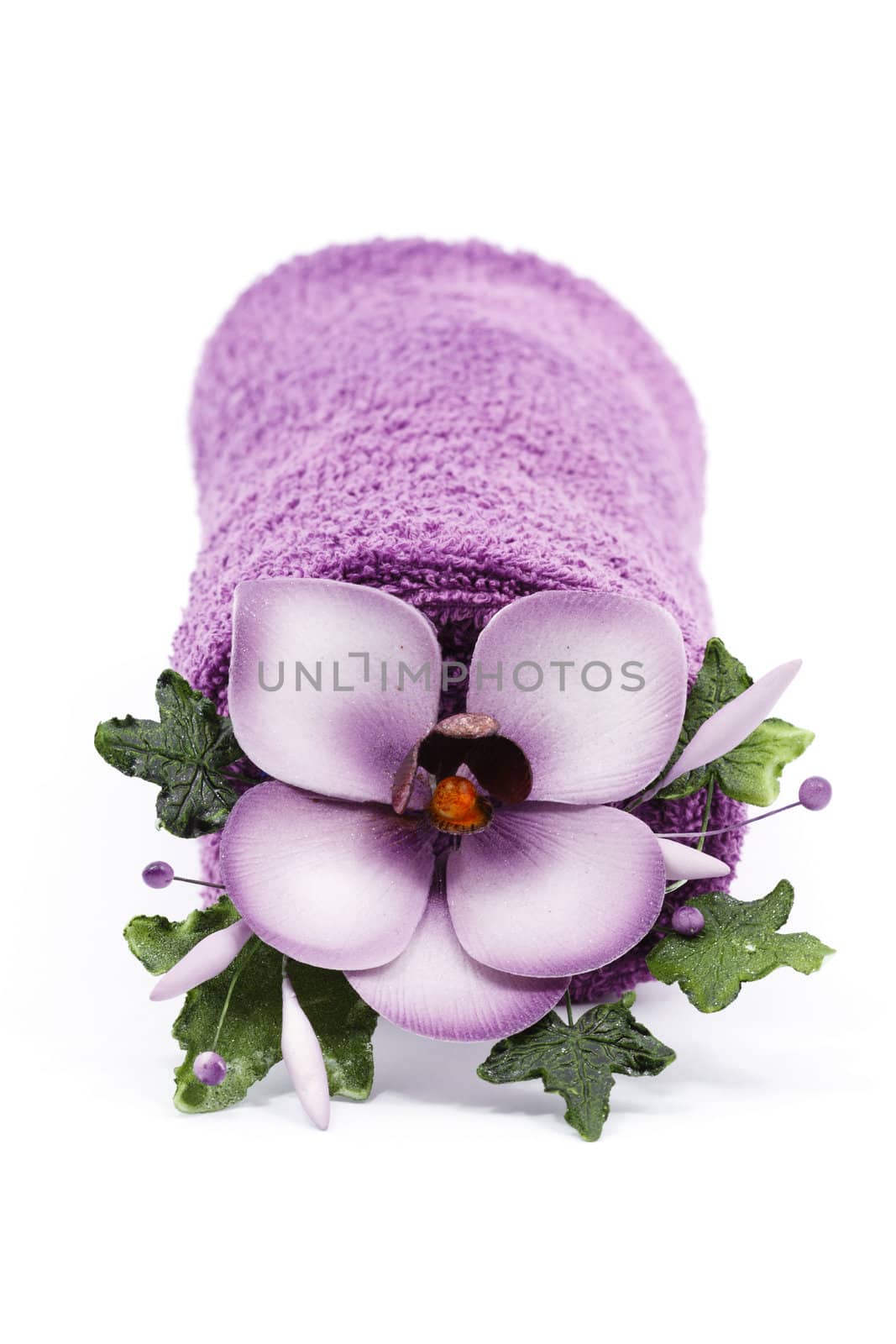 Purple towel and flower as a spa decoration isolated on white background