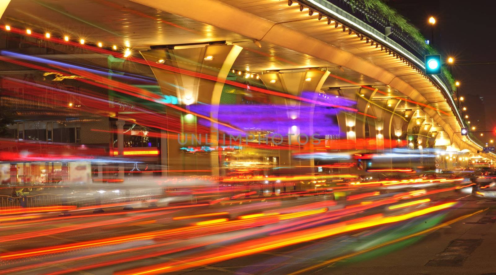 High speed traffic and blurred light trails under the overpass by jackq