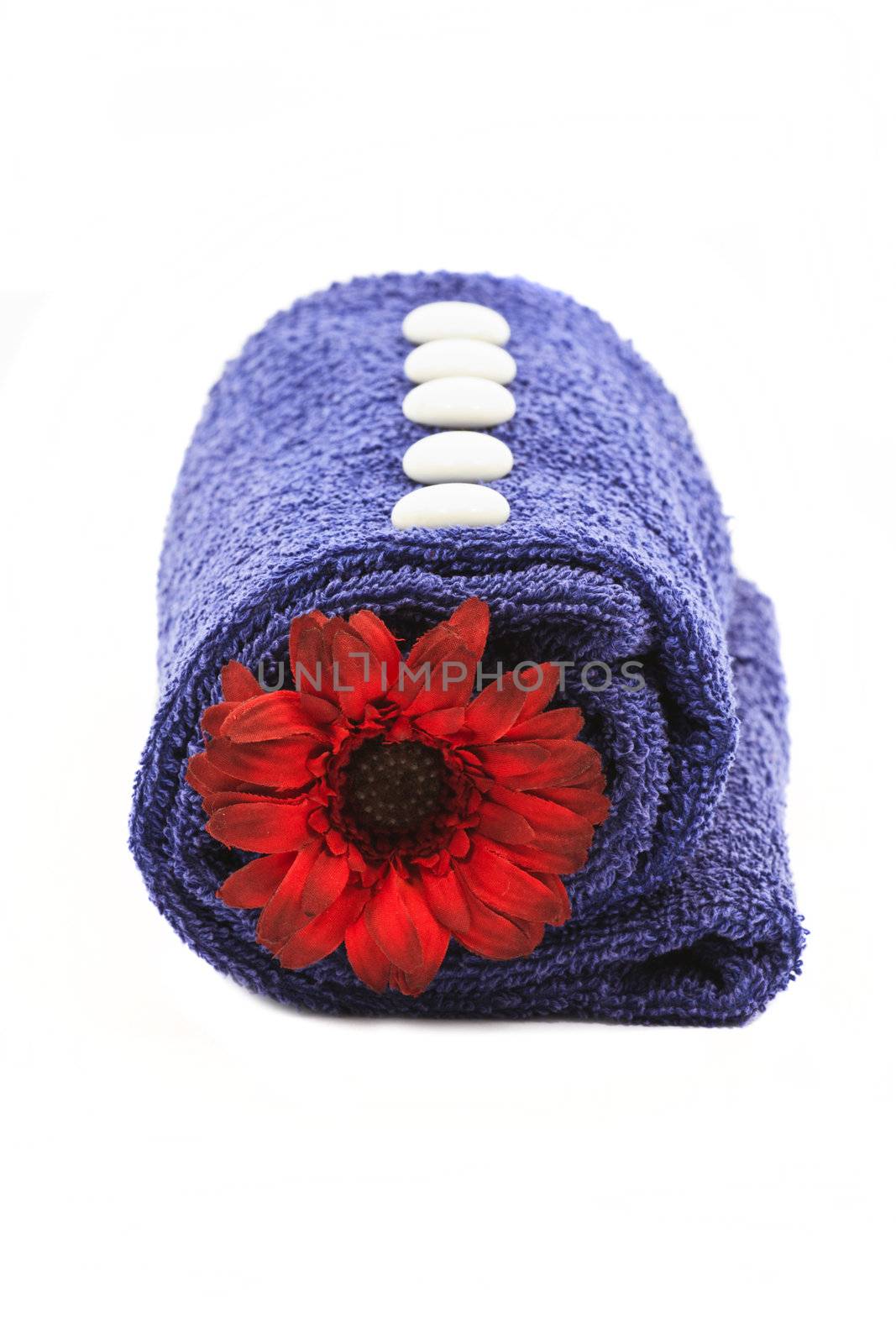 Beautiful decoration with blue towel and red flower isolated on white