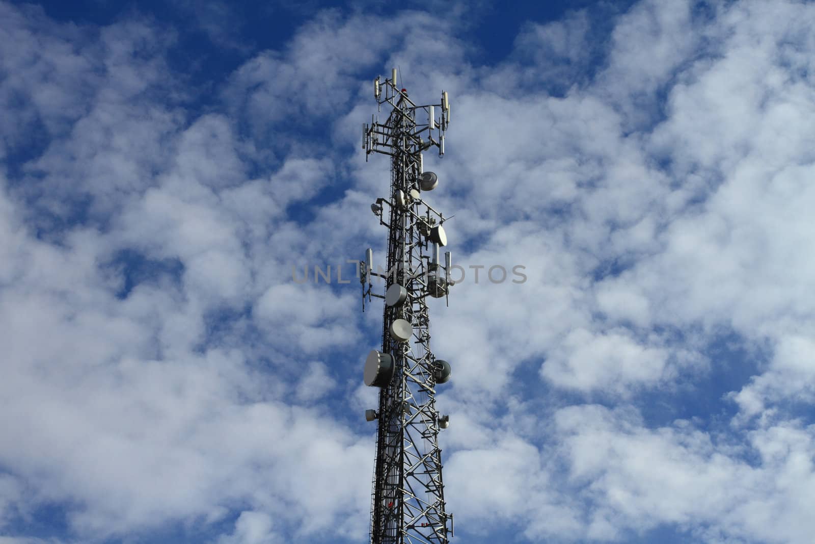 Large telecommunication tower with dramatic clouds in the sky