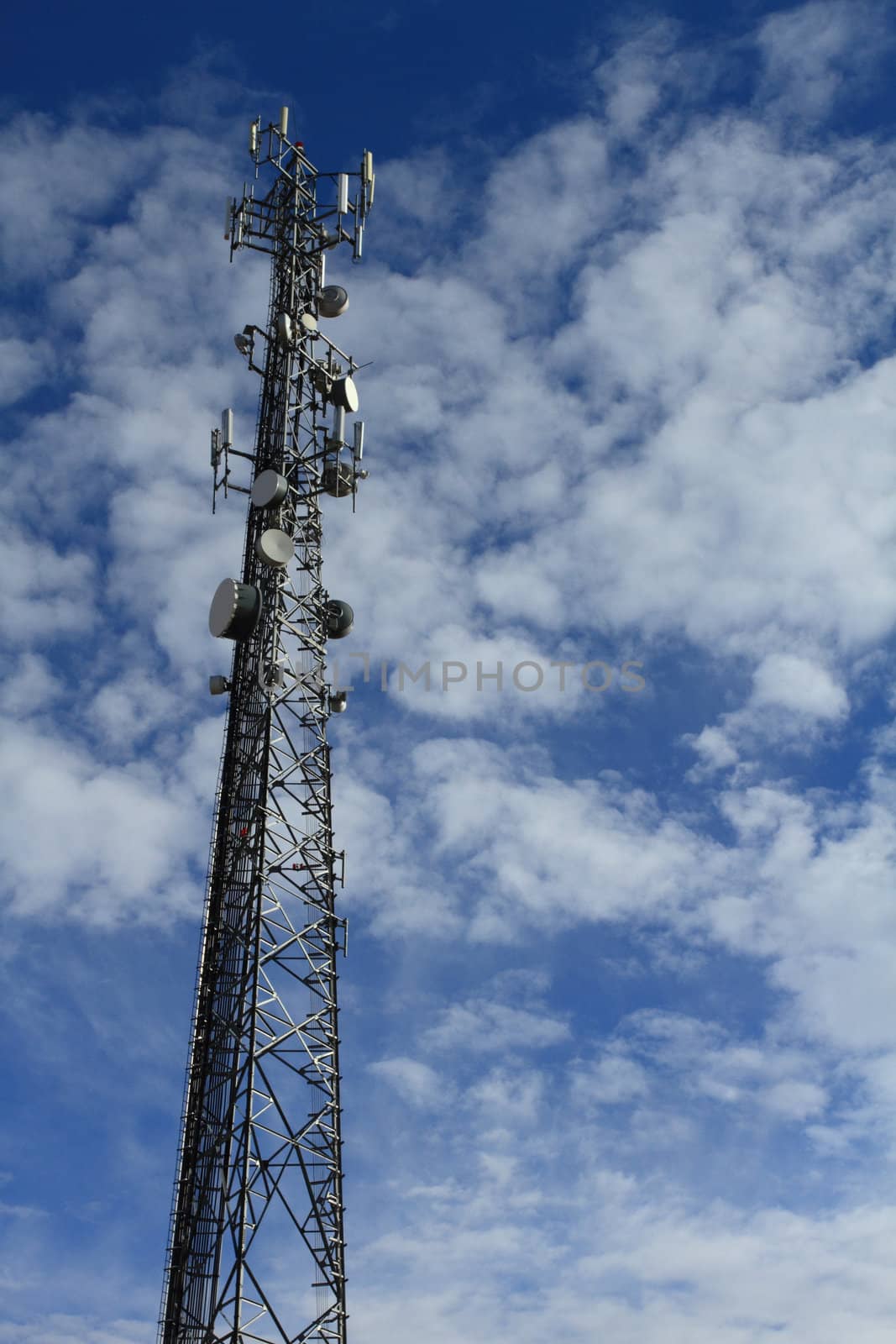 Large telecommunication tower with dramatic clouds in the sky