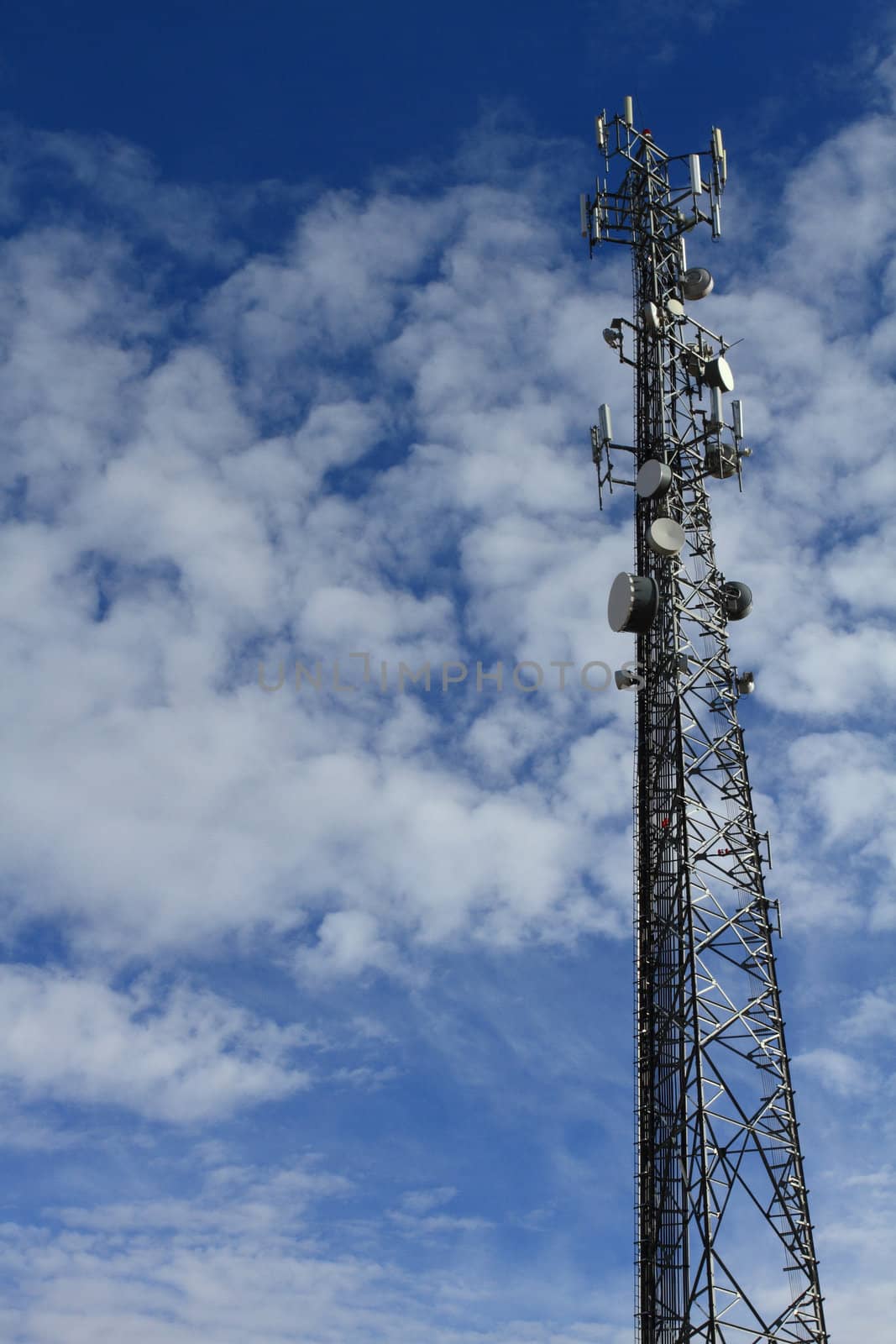Large telecommunication tower with dramatic clouds in the sky