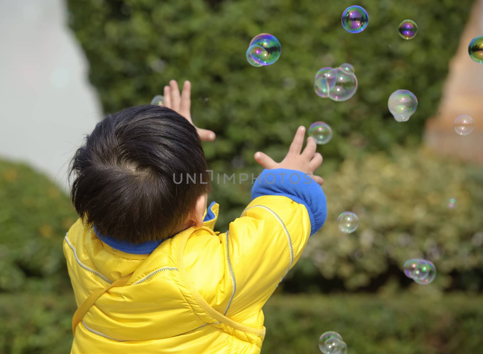 baby playing soap bubbles