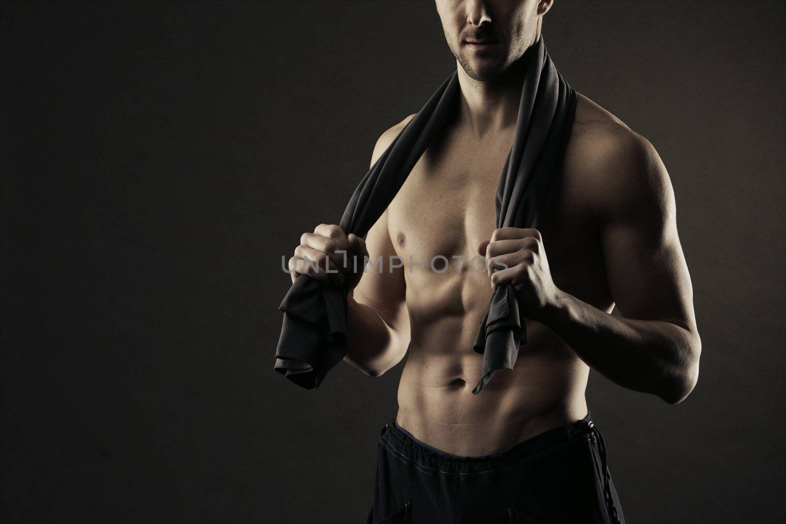Muscular, shirtless man with towel around neck