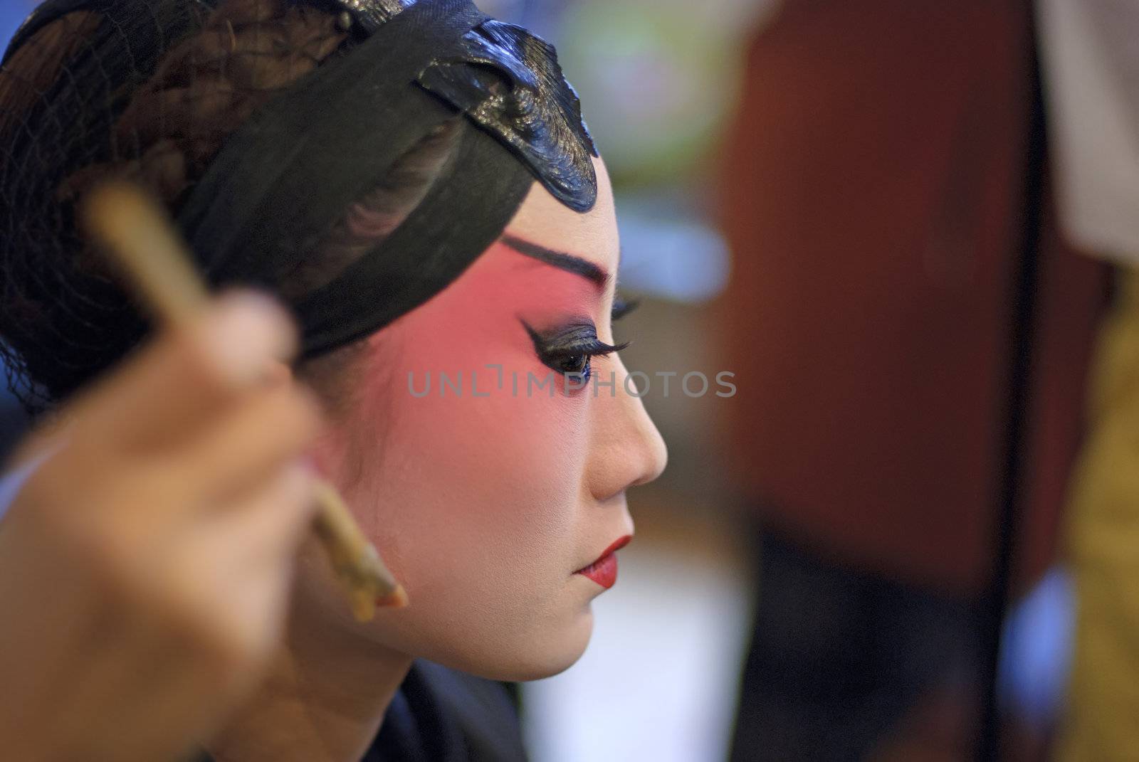 CHENGDU - Dec 15: a chinese opera actress is painting her face at backstage at JingJiang theater on Dec 15,2007 in Chengdu; China.