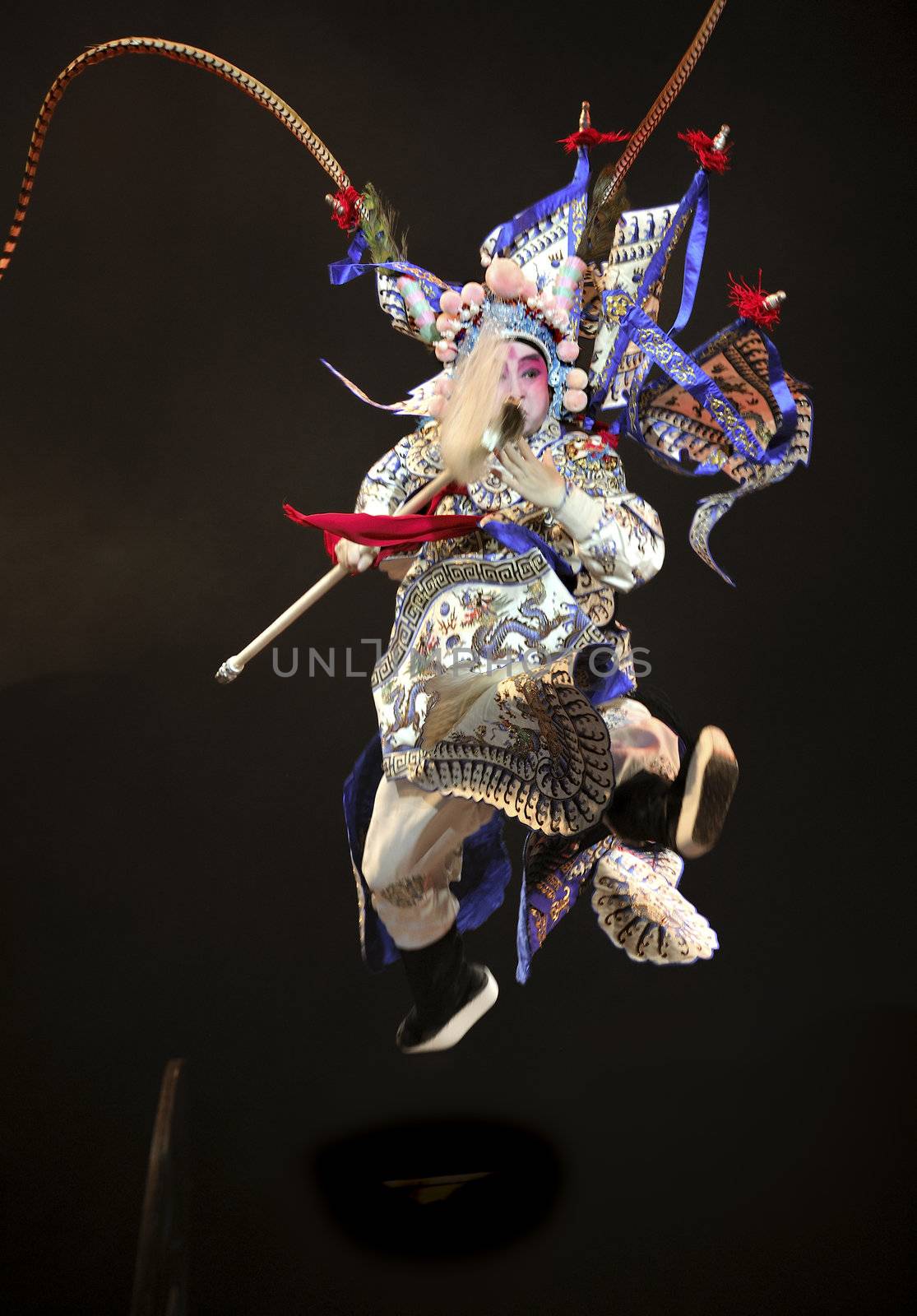 Jumping chinese opera actor with traditional costume by jackq