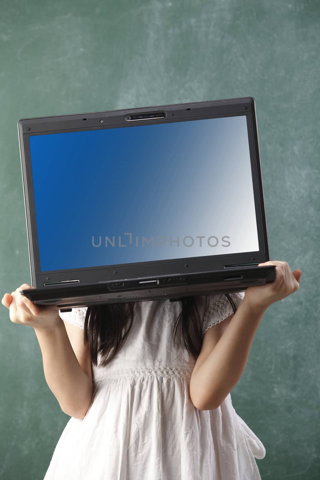 stock image of girl lifting a heavy laptop