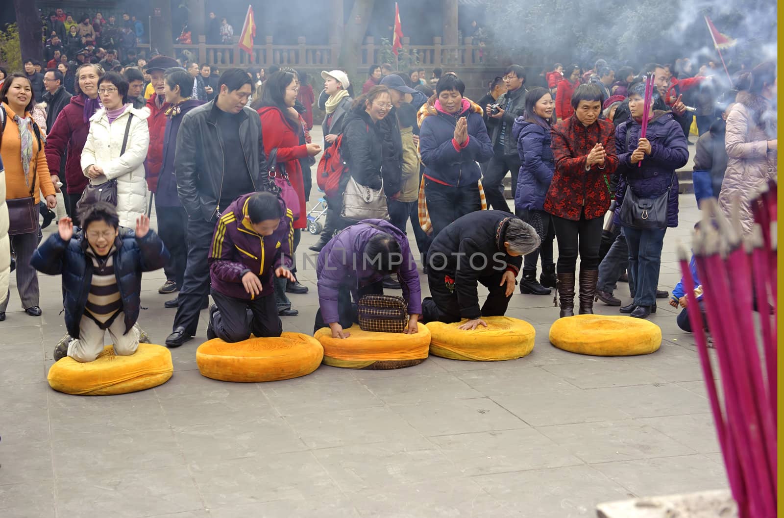 CHENGDU - FEB 5: People praying to Buddha in temple during chinese new year on Feb 5, 2011 in Chengdu, China.Many people want to relieve their worries and difficulties by burning incense and praying to Buddha during festivals.It's part of the important traditional custom in China.
