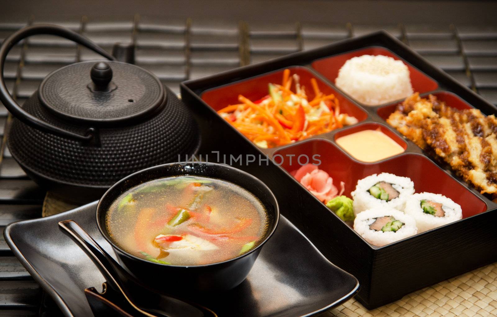 Sushi lunch with soup salad tea and sauce
