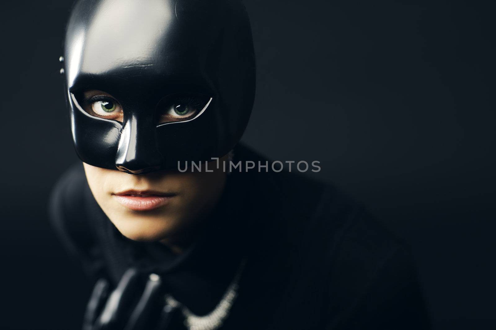 Portrait of female thief in black mask