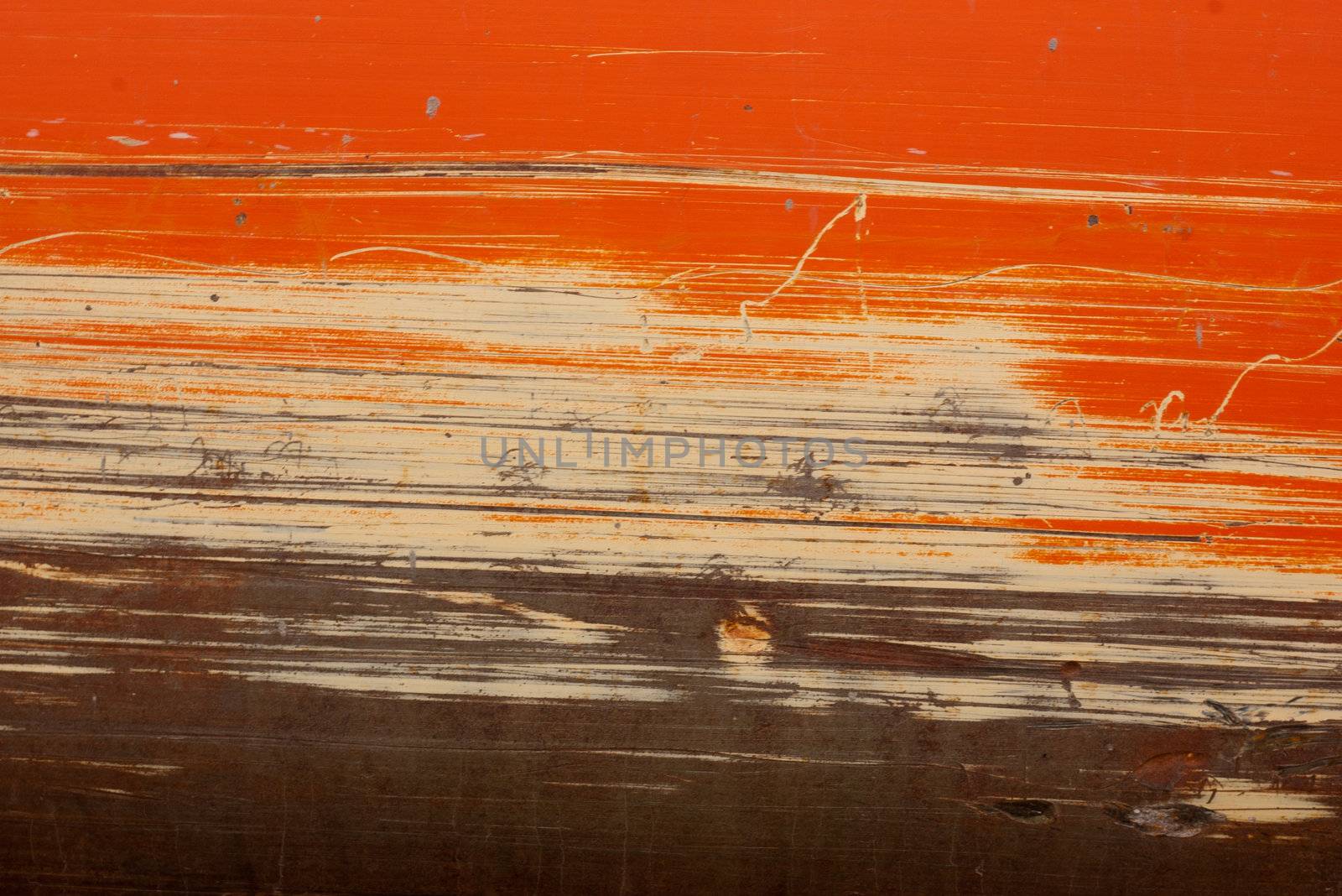 orange and tan scraping on construction equipment