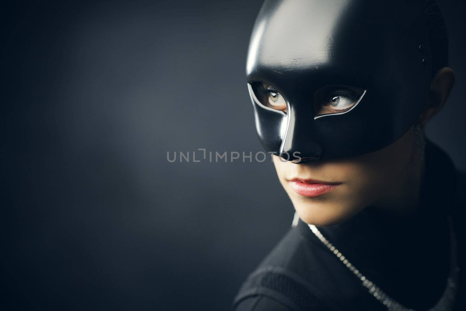 Portrait of female thief in black mask