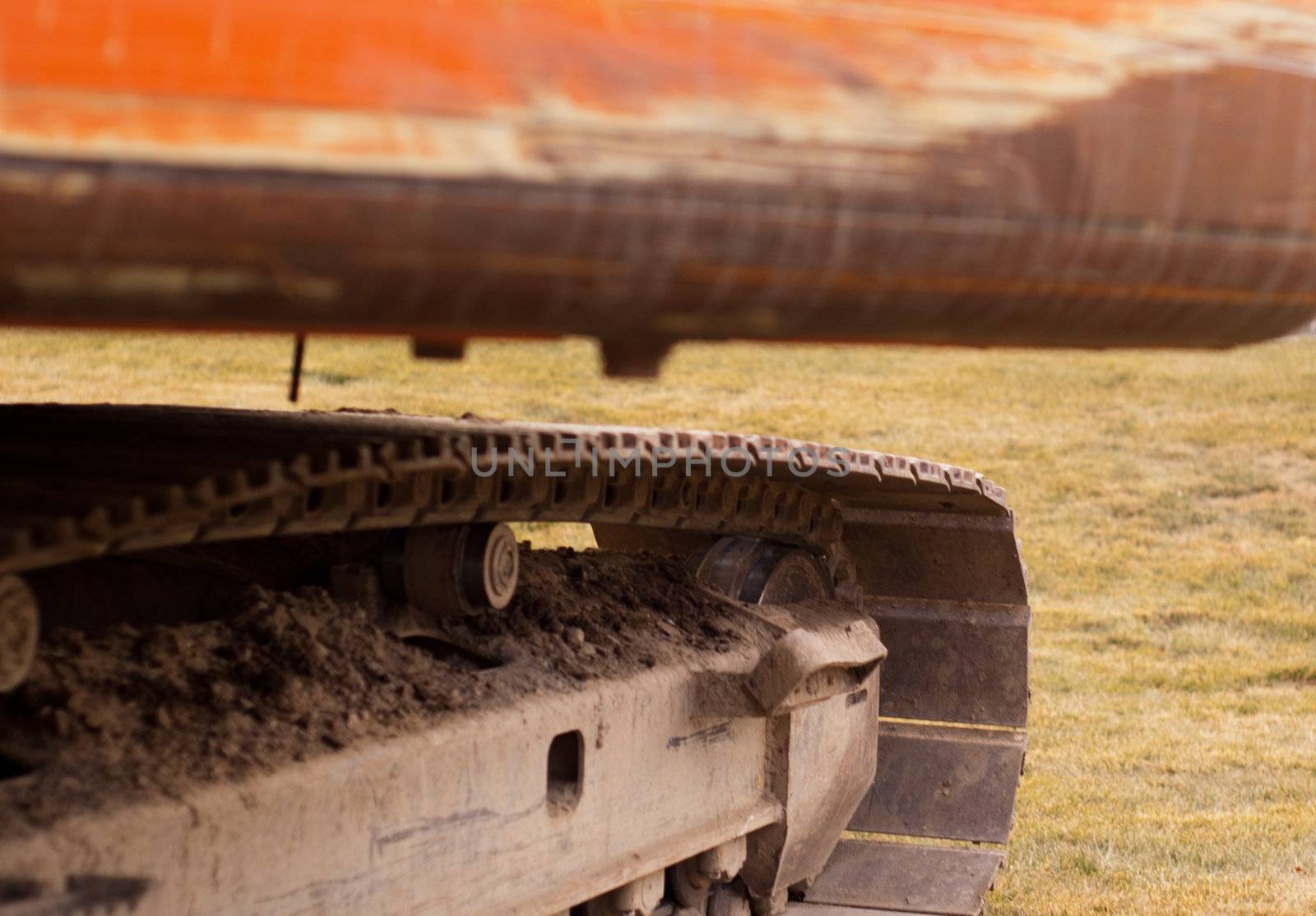 scratched back end of an orange trackhoe